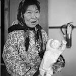 Female Inuit artist holding a sculpture [Rosa Arnarulluk] [between 1962-1969].