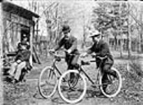 Norman and Adam Ballantyne with bicycles at 54 Main Street. James and Lilly Ballantyne are at left of photo April 1897.