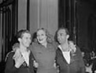 Lloyd Malenfant (left) and Wayne Sheridan (right) of the Navy Show, with Marlene Dietrich June 1945