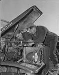 [Personnel of No. 191 Canadian Infantry Workshop, R.C.E.M.E., repairing truck carburetor, Korea, 19 March 1953.] 19 Mar. 1953