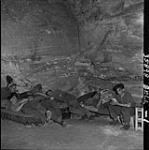 Troops of 9th Canadian Infantry Brigade relaxing in cave used by Germans for sleeping and captured by Canadians 02-Jul-44