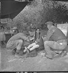 Medical personnel of the Seaforth Highlanders of Canada treating Italian girl with infected insect bites c.a. 29 Aug. 1943