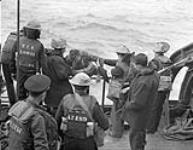 Survivors of a capsized Landing Craft Infantry (LCI) being helped aboard H.M.C.S. PRINCE HENRY off the Normandy beachhead, France, 6 June 1944 June 6, 1944.