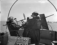 Able Seamen E. Westwood and W. McIver manning No.9 Oerlikon anti-aircraft gun aboard H.M.C.S. PRINCE HENRY off the Normandy beachhead, France, 6 June 1944 June 6, 1944.