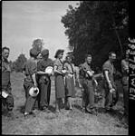 Pte. H. Ashworth and Pte. F. Shaddock, C.W.A.C., line up for food 12 Aug. 1944
