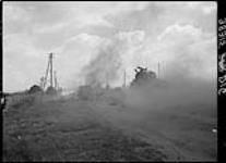 Burning Allied tanks and vehicles 10 Aug. 1944