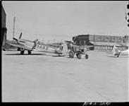 Seafire aircraft AAB being towed to taxying strip at RCAF airfield 10 Sept. 1948