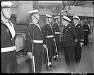 Rear-Admiral E.G.A. Clifford accompanied by Officer of the Guard Lt. P.A. Scott, inspects personnel of H.M.C.S. NOOTKA 8 Nov. 1952
