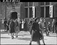 Girl collaborators being marched off through streets to prison after Liberation 9 Apr. 1945
