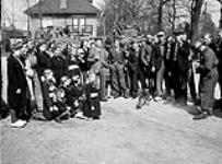 Lance-Corporal A.R. Labonté (right) of Le Régiment de Maisonneuve photographing Dutch children, Rijssen, Netherlands, 9 April 1945 April 9, 1945.