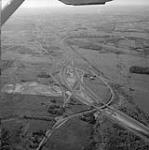 Aerial view looking northwest along Highway 417 May 1976.