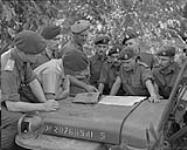 Arrival of 1st Bn. PPCLI in Korea. Brig. J.M. Rockingham shows officers of the 1st Bn. positions of the 25th Canadian Infantry Brigade on a map of Korea 4 Ot. 1951