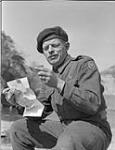 Pte. Jack Smith of Princess Patricia's Canadian Light Infantry reading a letter from Mrs. Annie Burks of Abilene, Texas 25 Mar. 1951
