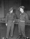 Corporal R.E. Jenkins (left) and Private H.L. Raser receive Military Medal at Buckingham Palace 8 May 1945