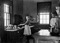 Romhild girl in kitchen at 54 Main Street, residence of James Ballantyne 17 March 1907.