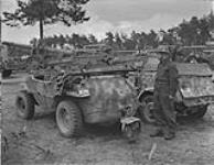 Pte. John Wojnowitch standing near a captured German amphibious jeep June 1945