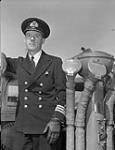 Commander Harry G. DeWolf, Commanding Officer, on the bridge of the destroyer H.M.C.S. HAIDA, 5 May 1944 May 5, 1944.