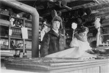 An inside view of the Hudson's Bay Company store with Mr. Hampton, the clerk, in foreground 1929