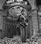 General Sir Bernard L. Montgomery standing in nave of ruined church 13 Dec. 1943
