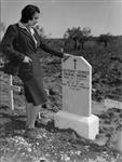 Signora Maria Theresa Berardi looking at grave of Lieutenant Georges Frederic Chicoine, of the Royal 22nd Regiment 13 Mar. 1944