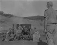 Royal Canadian Horse Artillery's one hundredth round being fired. Brig. Rockingham and in foreground, gun commander Lieut. G. B. Fullerton 14 Ot. 1951