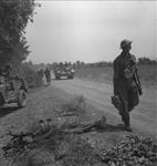 Personnel of the Cape Breton Highlanders advancing past dead German soldier 24 May 1944