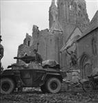 Armoured vehicle in front of ruined War Monument and Church 04-Jul-44