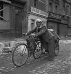 Civilian returning to Caen with his few belongings in a cart attached to his bicycle 10-Jul-44