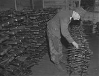Prisoner storing bayonets and rifles 17 May 1945