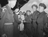 Princess Juliana of the Netherlands receiving a cheque for 1100 pounds sterling to start a fund for children of the Nijmegen district who suffered through the war, from the Princess Louise Kensington Regiment (British) 2 June 1945