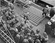 Infantrymen of the 1st Battalion, The Canadian Scottish Regiment, at prayer before boarding a Landing Craft Assault (LCA) to go ashore from H.M.C.S. PRINCE HENRY off the Normandy beachhead, France, 6 June 1944 June 6, 1944.