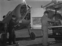 Two mechanics servicing a Norwegian P-36 at "Little Norway" Training Centre Flying Field Apr. 1941
