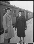 Lieutenant-Colonel D.A. Clarke of the Canadian Wives' Bureau and Miss M. R. Duff of Canadian Red Cross Hostels at train taking Canadian war brides and children to Liverpool en route to Canada 4 Dec. 1944