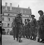 Brig. Maj. N. Kingmill inspects Guard of the H.L.I. of Canada, under German mortar and shell 11-Jul-44