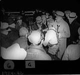 MOOSE RIVER MINE RESCUE. Dr. W.E. Gallie (with flashlight) greets his friend Dr. D.E. Robertson as he came out of the mine supported by draegermen Gordon, Hershfield, Simpson and Morell. Charlie Ivey is behind Dr. Gallie 24 Apr. 1936