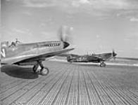 Supermarine Spitfire IXE aircraft of No. 412 (Falcon) Squadron, RCAF, preparing for takeoff Marh 22, 1945.