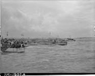 View looking west along 'Nan White' Beach, showing LCI(L)s of the 3rd Canadian (264th RN) Flotilla landing personnel of the 9th Canadian Infantry Brigade on D-Day 6 June 1944