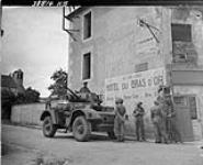 S.S/M Billet and infantry troops of the Belgium Brigade on a street corner, Sallenelles, France, 16 August 1944 16 Aug. 1944