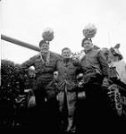 Sergeants C.M. Olson and H.P. Sprague, both of The Calgary Highlanders, with a Dutch civilian, Putte, Netherlands, 6 October 1944 October 6, 1944.