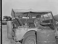 Canadian personnel of the 1st Commonwealth Division competing in jeep rally. (Left to right): Pte. Bill Murphy, L/Cpl. Thomas Latta, Lt. Don Laut. Korea, 23 June 1954 23 JUNE 1954