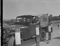 Canadian personnel of the 1st Commonwealth Division competing in jeep rally. (Left to right): Pte. Frank Bevins, Lt. Edward Blake, Cpl. Herb Read. Korea, 23 June 1954 23 JUNE 1954