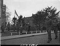 Lt.-Gen. C.E. Foulkes taking salute from marching troops at 1st Canadian Corps Headquarters. Oss, Netherlands, April 1945 Apr. 1945