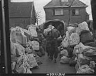 Christmas mail being unloaded by men of the Pioneer Corps at the 2 Canadian Corps Army Post Office. Oss, Netherlands, 6 Dec. 1944 6 DEC. 1944