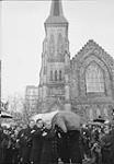 Lester B. Pearson Funeral. Royal Canadian Mounted Police (R.C.M.P.) pall bearers carrying casket in front of Christ Church Cathedral. Ottawa, Ont., 31 Dec. 1972 31 DEC. 1972