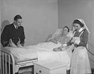 Dr. Lea Steeves, Lt. I. Tate, Valleyfield survivor and N/S Smith at Royal Canadian Naval Hospital. St. John's, NFLD, July 1944 Jul-44