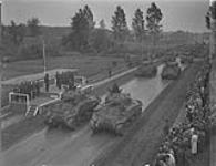 Lt. Col. Jack Eaton leading his regiment, the 8th New Brunswick Hussars, past the saluting base in the review and marchpast of the 5 Canadian Armoured Division given by GOC in C of 1st Canadian Corps. General Crerar, at 23 May 1945.