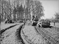 Bulldozer towing 'Crocodile' armoured vehicle of the 1st Fife and Forfar Yeomanry out of mud. Bathmen, Netherlands, 9 April 1945 9 Apr. 1945
