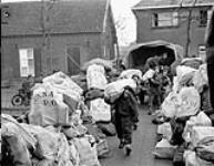 Unloading of sacks of Christmas mail at 2nd Canadian Corps Post Office, Canadian Postal Corps (C.P.C.), Oss, Netherlands, 6 December 1944 December 6, 1944.