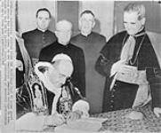 Pope Paul VI signing guest book at the Pontifical Canadian College. At his right is Paul Emile, Cardinal Leger, Archibishop of Montreal 14 Nov. 1963