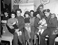 Corporal A. Lobsenzer of the U.S. Army, Private Eve Keller of the Canadian Women's Army Corps (C.W.A.C.), Private H. Fishman and Lance-Corporal E. Sassoon with children during the Jewish celebration of Hanukkah, Tilburg, Netherlands, 17 December 1944 Deember 17, 1944.